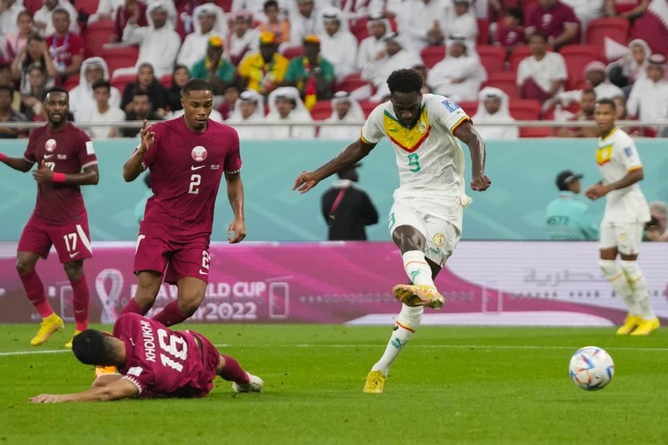 Senegal's Boulaye Dia scores his side's first goal during the World Cup group A football match between Qatar and Senegal, at the Al Thumama Stadium in Doha, Qatar, Friday, Nov. 25, 2022. (AP Photo/Thanassis Stavrakis)