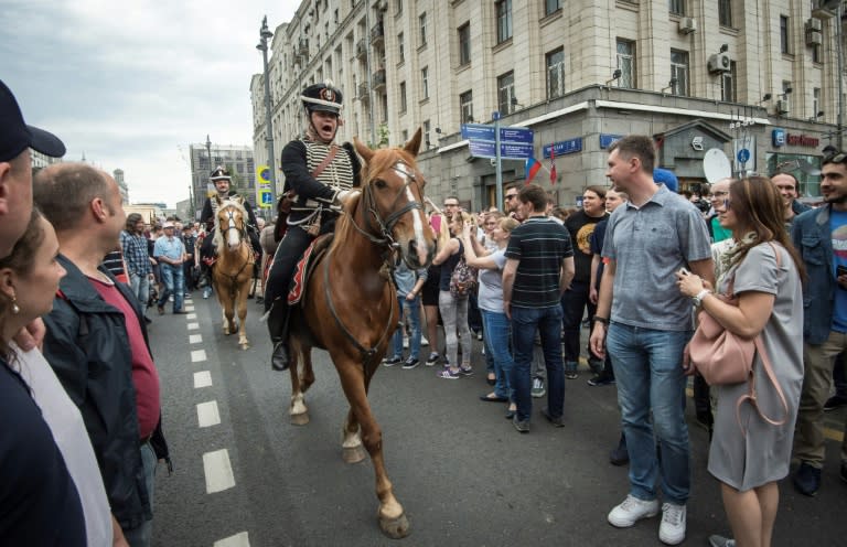 In bizarre scenes, demonstrators in the protest mingled with those taking part in celebrations for Russia Day, which saw reenactments of key moments in Russian history