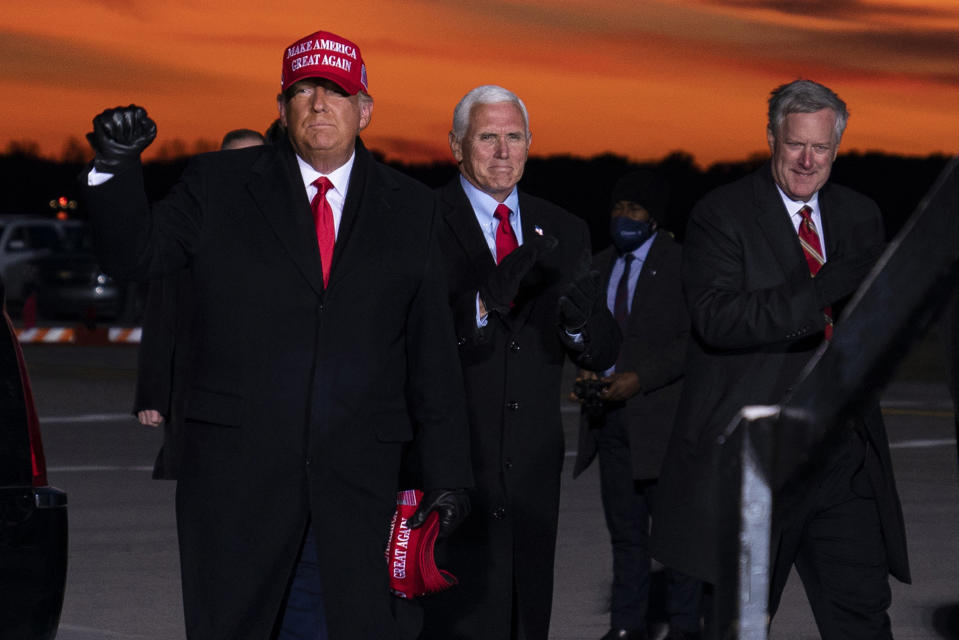 President Donald Trump and Vice President Mike Pence arrive for a campaign rally at Cherry Capital Airport, Monday, Nov. 2, 2020, in Traverse City, Mich., with White House chief of staff Mark Meadows, right. Meadows has been diagnosed with the coronavirus as the nation sets daily records for confirmed cases for the pandemic. (AP Photo/Evan Vucci)