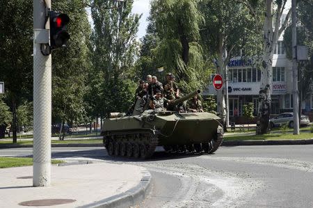 Pro-Russian separatist fighters from the so-called Battalion Vostok (East) travel on an armoured vehicle in the eastern Ukrainian city of Donetsk, July 10, 2014. REUTERS/Maxim Zmeyev