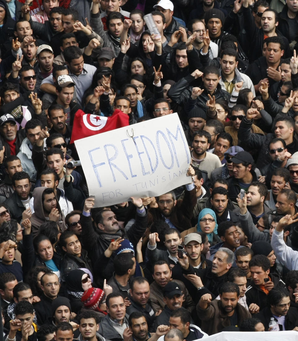 Protesters chant slogans against President Zine El Abidine Ben Ali in Tunis, Friday, Jan. 14, 2011. Some thousands of angry demonstrators marched through the Tunisian capital Friday, demanding the resignation of the country's autocratic leader a day after he appeared on TV to try to stop deadly riots that have swept the North African nation. On Thursday Jan. 14, 2021, Tunisia commemorates 10 years since the flight into exile of its iron-fisted leader, Zine El Abidine Ben Ali, pushed from power in a popular revolt that foreshadowed the so-called Arab Spring. (AP Photo/Christophe Ena)