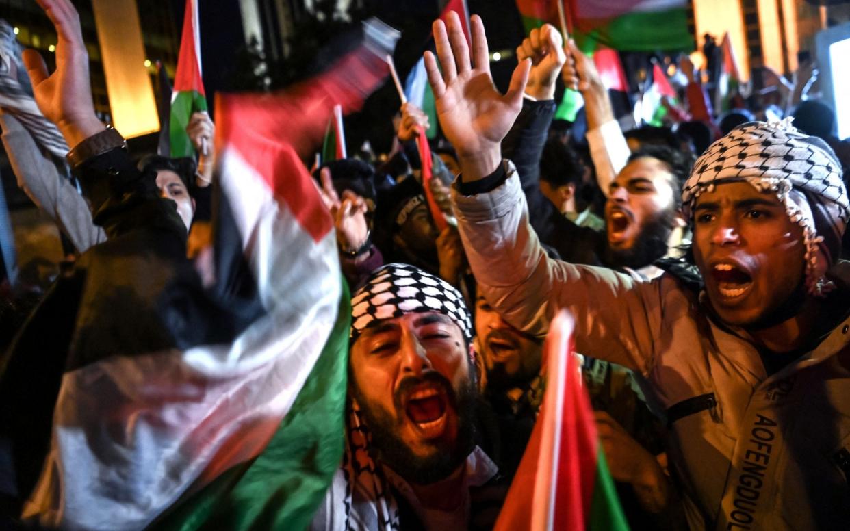 Protesters chant slogans and wave Palestinian flags during a protest against Israel in front of the Israeli Consulate in Istanbul, late on May 10, 2021 - OZAN KOSE /AFP