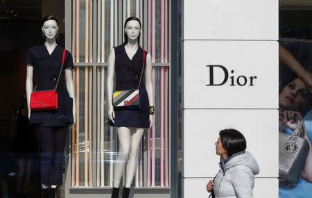 A woman walks past a Dior shop in downtown Brussels, Belgium March 10, 2016. REUTERS/Yves Herman