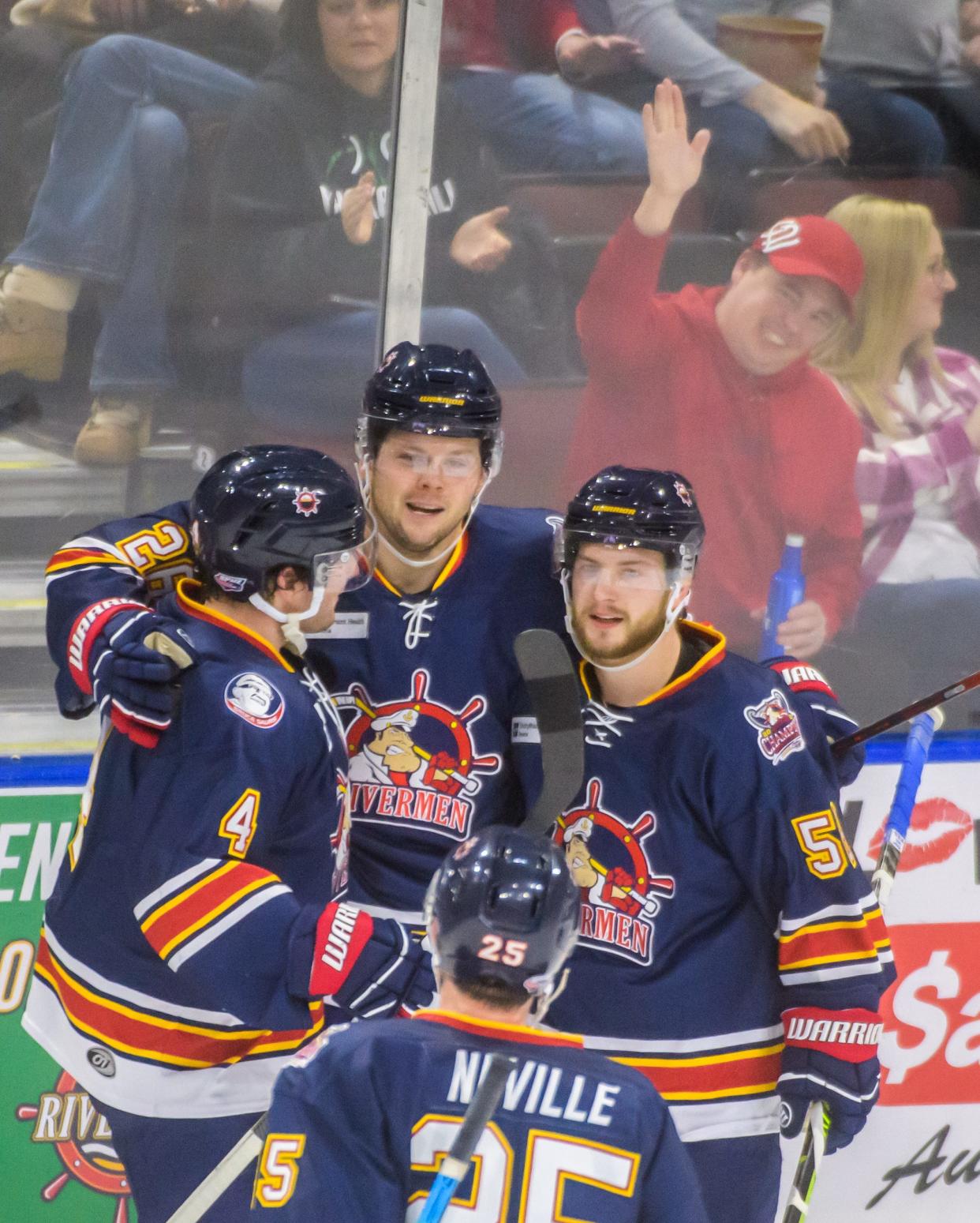 New Rivermen center Andrew Durham, middle, and his teammates celebrate his goal against Evansville in the second period Friday, Dec. 30, 2022 at Carver Arena. The Rivermen defeated the Thunderbolts 5-1. 