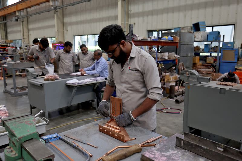 FILE PHOTO: Employees assemble an electric transformer inside a manufacturing unit of Electrotherm (India) Private Limited at Sanand GIDC (Gujarat Industrial Development Corporation), on the outskirts of Ahmedabad