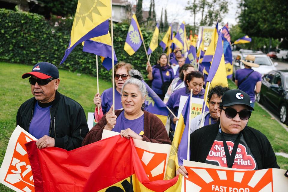 Pizza Hut workers and their supporters march