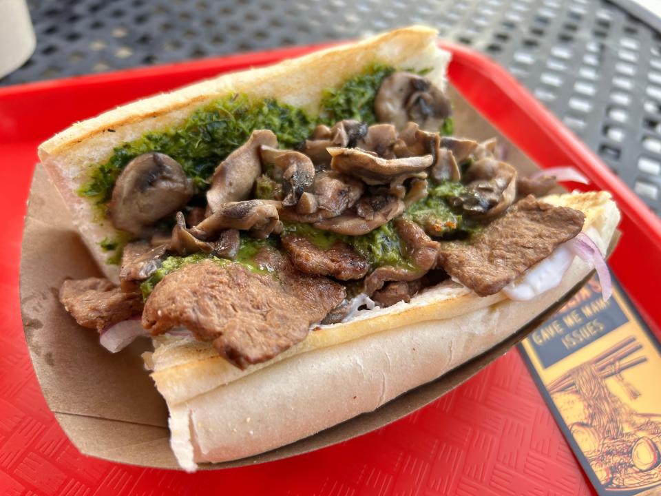 The vegan Pogi sandwich at Maya Ophelia's food truck features plant-based "stek," buttered mushrooms, sliced red onion, cilantro cream and chimichurri on a toasted baguette.