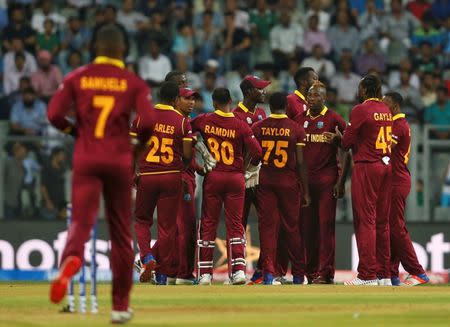 Cricket - West Indies v England - World Twenty20 cricket tournament - Mumbai, India, 16/03/2016. West Indies players celebrate the dismissal of England's Jason Roy. REUTERS/Danish Siddiqui