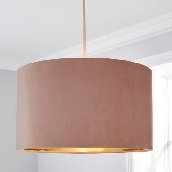 <p>This velvet shade from Dunelm is the kind of classic blush pink that won't feel dated in a few years. The eye-catching gold metallic inner is great for providing a soft yellow glow.</p><p><strong>Shop now: <a href="https://www.dunelm.com/product/clara-drum-shade-40cm-1000169122" rel="nofollow noopener" target="_blank" data-ylk="slk:Clara 40cm Drum Shade at Dunelm;elm:context_link;itc:0;sec:content-canvas" class="link ">Clara 40cm Drum Shade at Dunelm</a></strong></p>