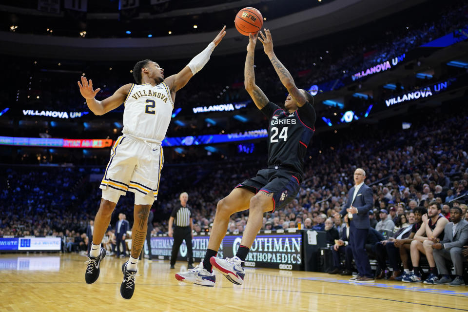 UConn's Jordan Hawkins, right, goes up for a shot against Villanova's Mark Armstrong during the second half of an NCAA college basketball game, Saturday, March 4, 2023, in Philadelphia. (AP Photo/Matt Slocum)