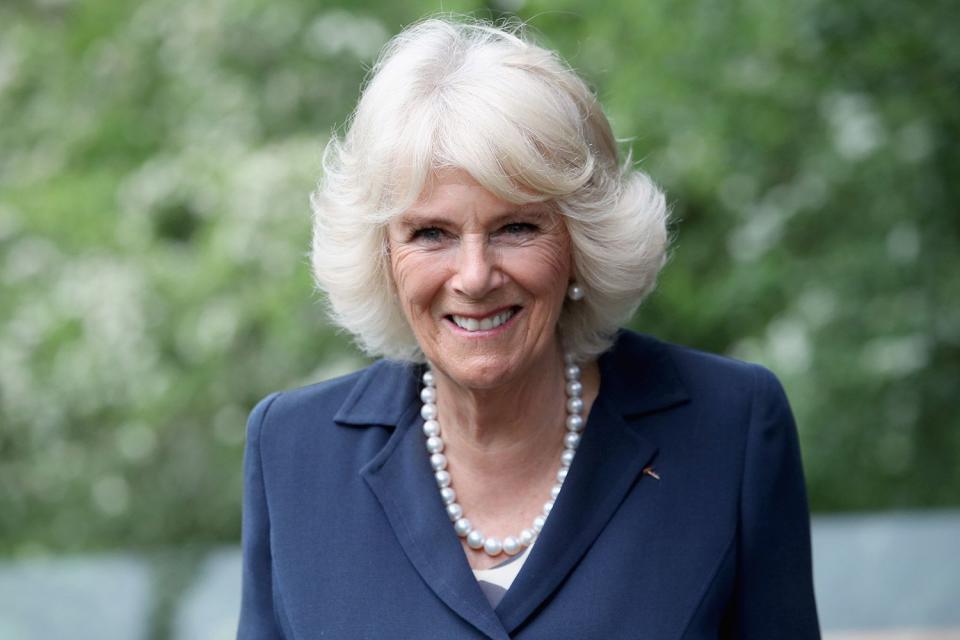 <p>Chris Jackson/Getty</p> Queen Camilla smiles during a visit to Maggie