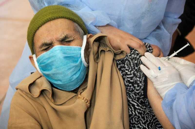 FILE PHOTO: An elderly man receives the COVID-19 vaccine during a national coronavirus vaccination campaign, in Sale