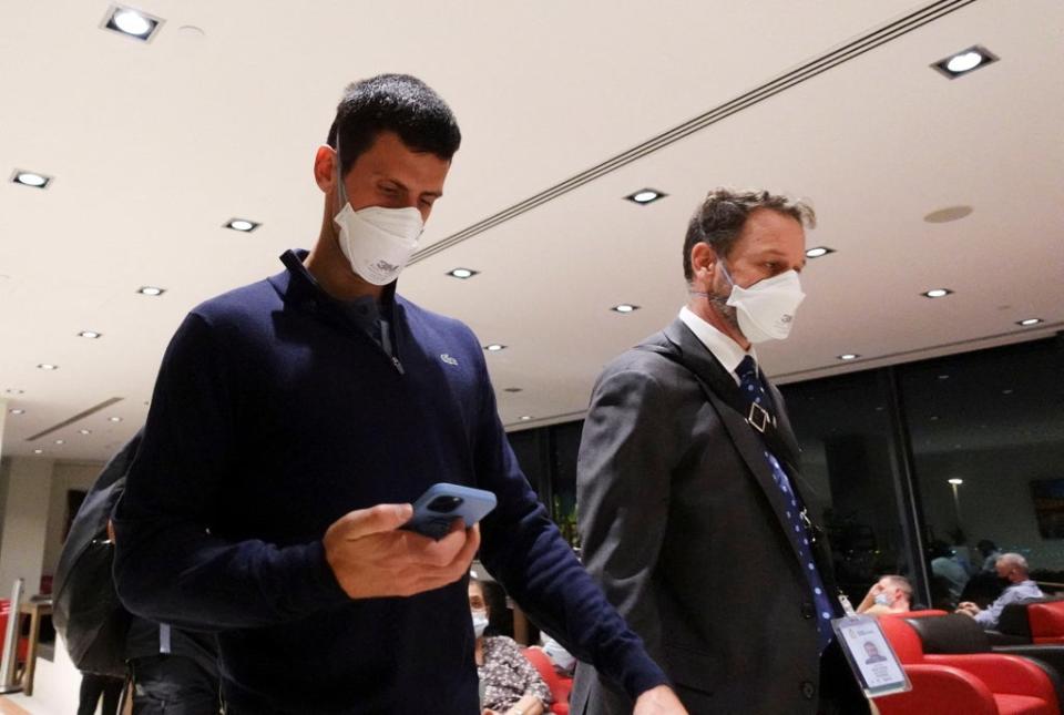 Novak Djokovic walks in Melbourne Airport before boarding a flight (REUTERS)