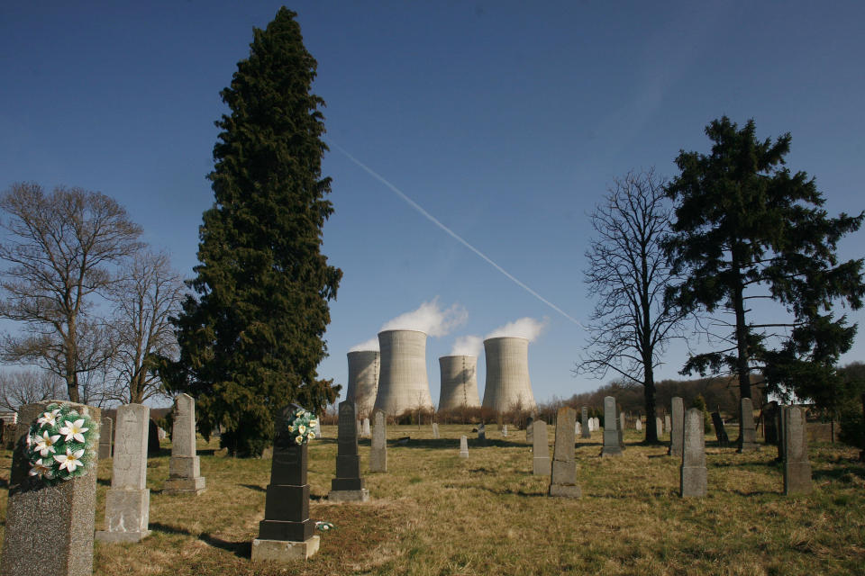 FILE - A cemetery is seen in front of the cooling towers of the blocks 1 and 2 of the Mochovce nuclear power plant about 160 kilometers (100 miles) east of Bratislava, Slovakia on Thursday March 15, 2007. In the wake of the Russian-Ukrainian war, Slovakia, which relies on Rosatom subsidiary Tvel for nuclear fuel, has turned to different suppliers. (AP Photo/Petr David Josek, File)