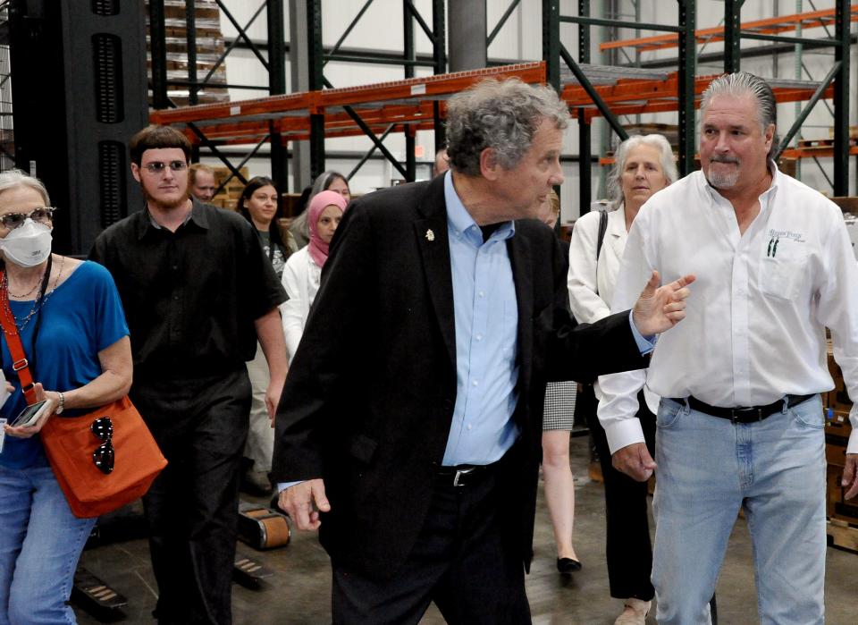 Sen. Sherrod Brown checks out a large warehouse for sorting and packaging vegetables for shipment during a tour of an Amish organic farm in Wayne County on Tuesday. Brown participated in a roundtable discussion to hear concerns of Ohio farmers.