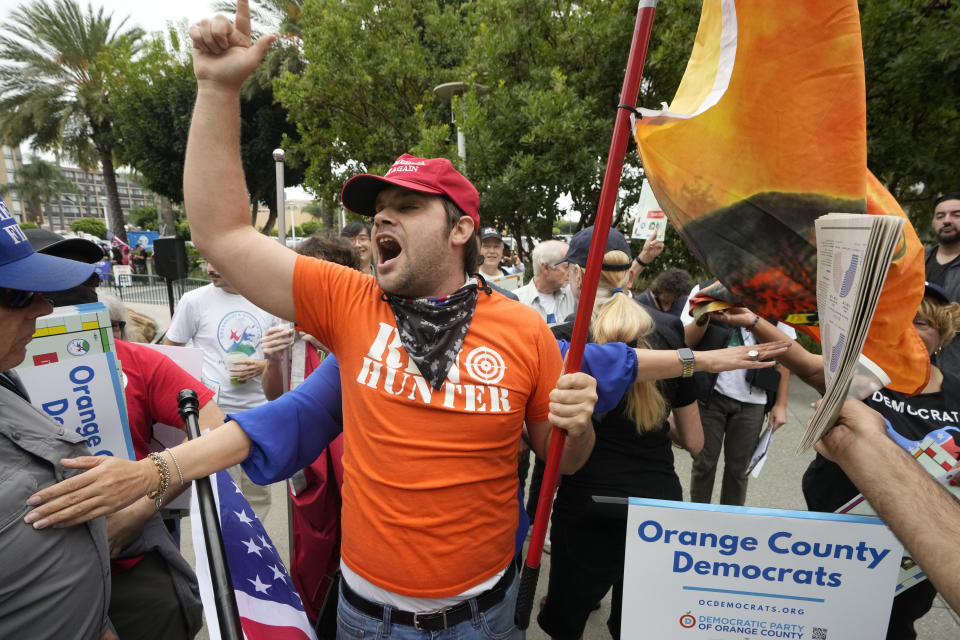 A former President Donald Trump supporter engages with members of Democratic Party of Orange County holding a rally where the 2023 Fall California Republican Convention is being held in Anaheim, Calif., Friday, Sept. 29, 2023. (AP Photo/Damian Dovarganes)