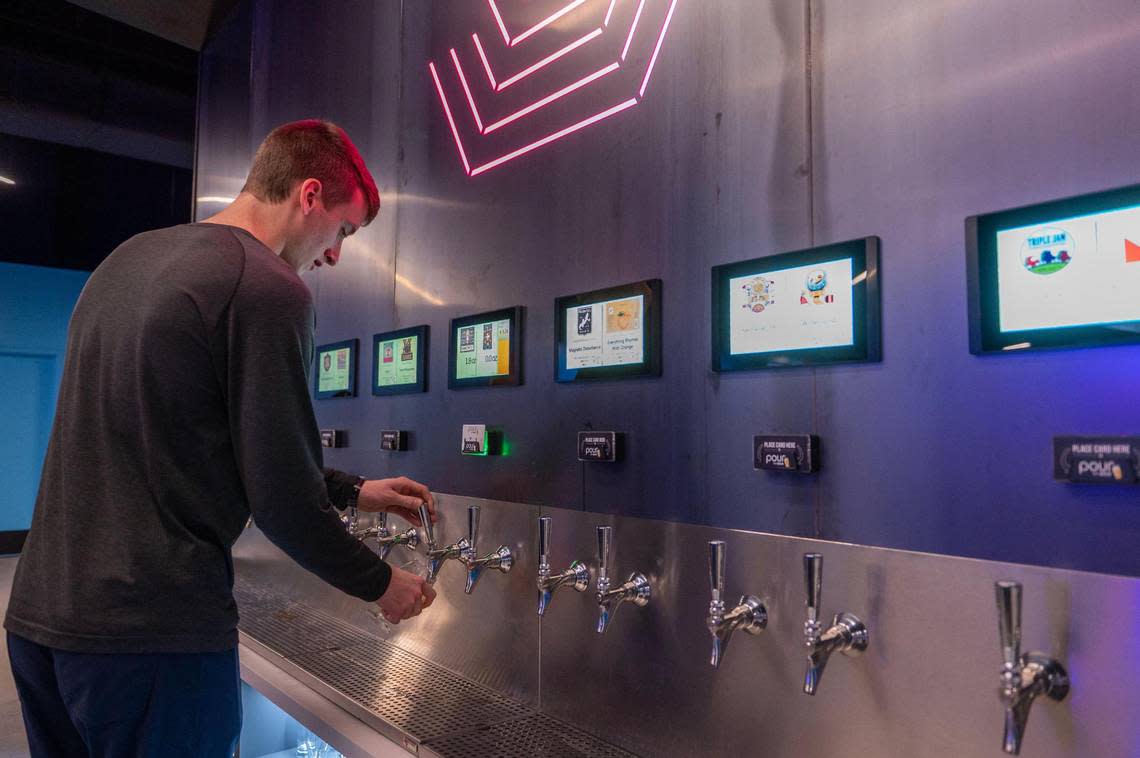 Kyle Funke pours beer from a tap at Brkthrough recreation center.