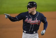 Atlanta Braves' Freddie Freeman points after a home run during the first inning in Game 1 of a baseball National League Championship Series against the Los Angeles Dodgers Monday, Oct. 12, 2020, in Arlington, Texas.(AP Photo/Tony Gutierrez)