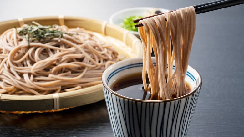 Dipping soba noodles in sauce