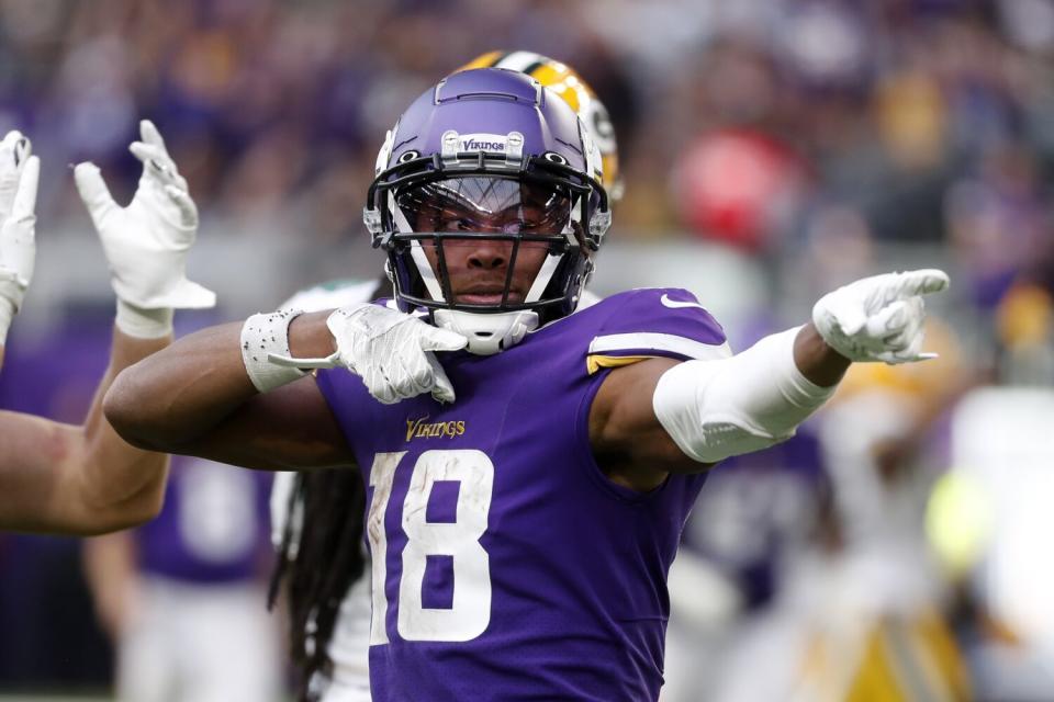 Minnesota Vikings wide receiver Justin Jefferson (18) celebrates after catching a pass.