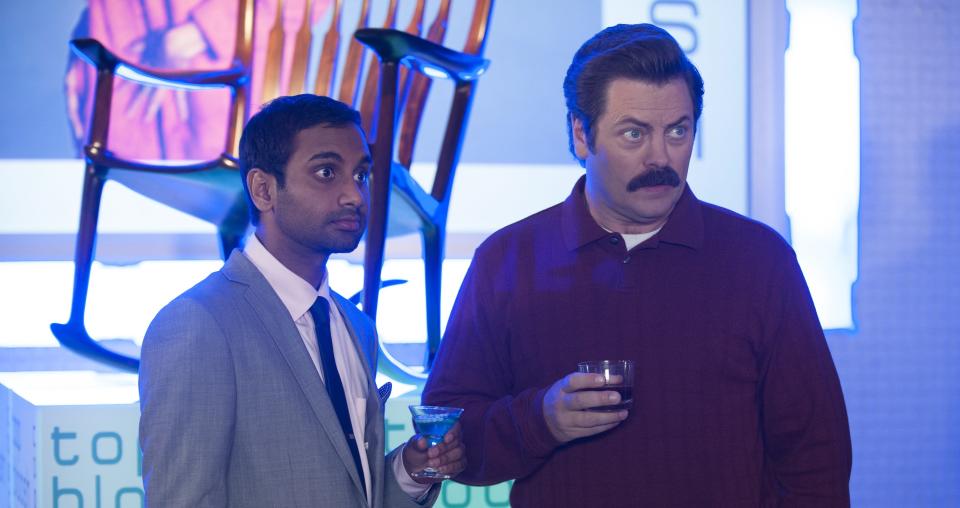 Ron and Tom holding drinks at "Parks and Recreation"