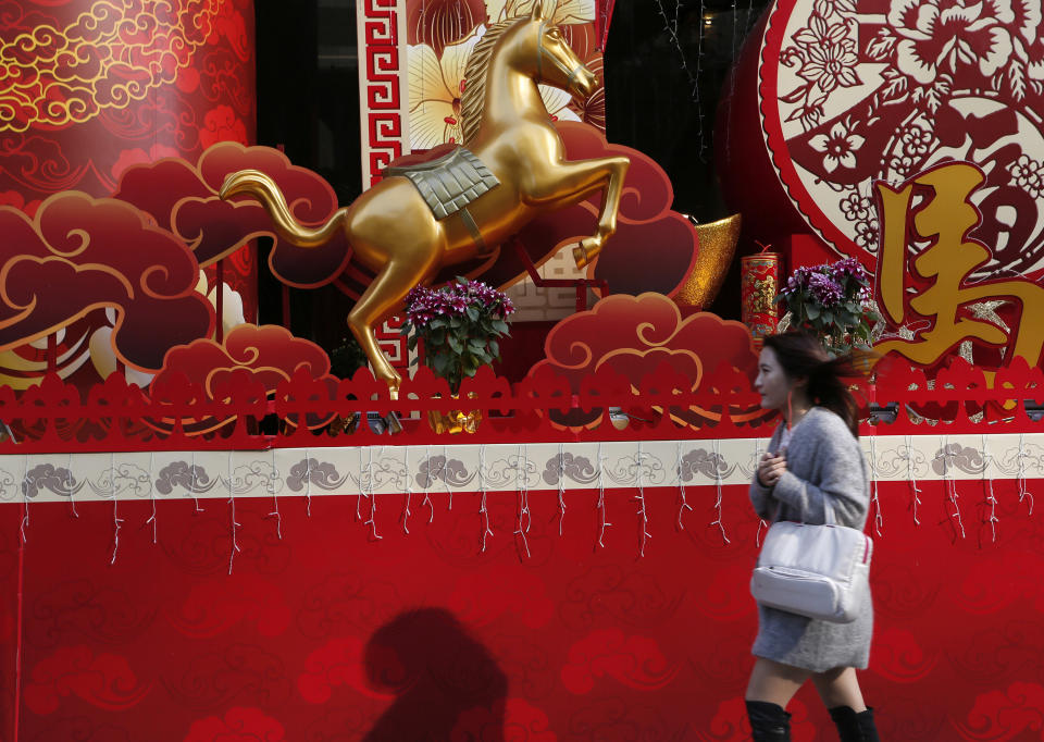 In this Monday, Jan. 27, 2014 photo, Chinese New Year decorations with a golden horse are displayed outside a building in Hong Kong. Chinese communities around the world were welcoming the arrival of the year of the horse on Friday, Jan. 31 with equine-themed decorations and celebrations. The annual Lunar New Year holiday is mark with particular verve in Hong Kong, the semi-autonomous Chinese financial center that expects 7.93 million visitors, more than territory’s permanent population of 7.1 million. (AP Photo/Vincent Yu)