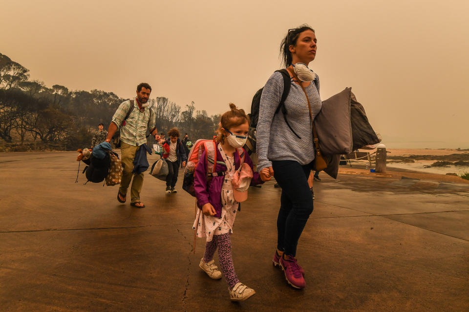 People stranded in Mallacoota after the bushfires that ravaged the town on December 30 are evacuated by army personnel to the HMAS Choules.