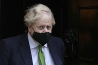 Britain's Prime Minister Boris Johnson leaves 10 Downing Street to attend the weekly session of Prime Minister's Questions in Parliament in London, Wednesday, Jan. 19, 2022. (AP Photo/Kirsty Wigglesworth)