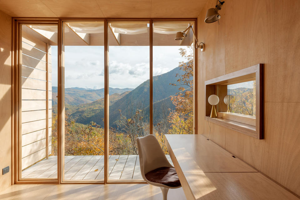 tiny house with tulip chair and wooden desk