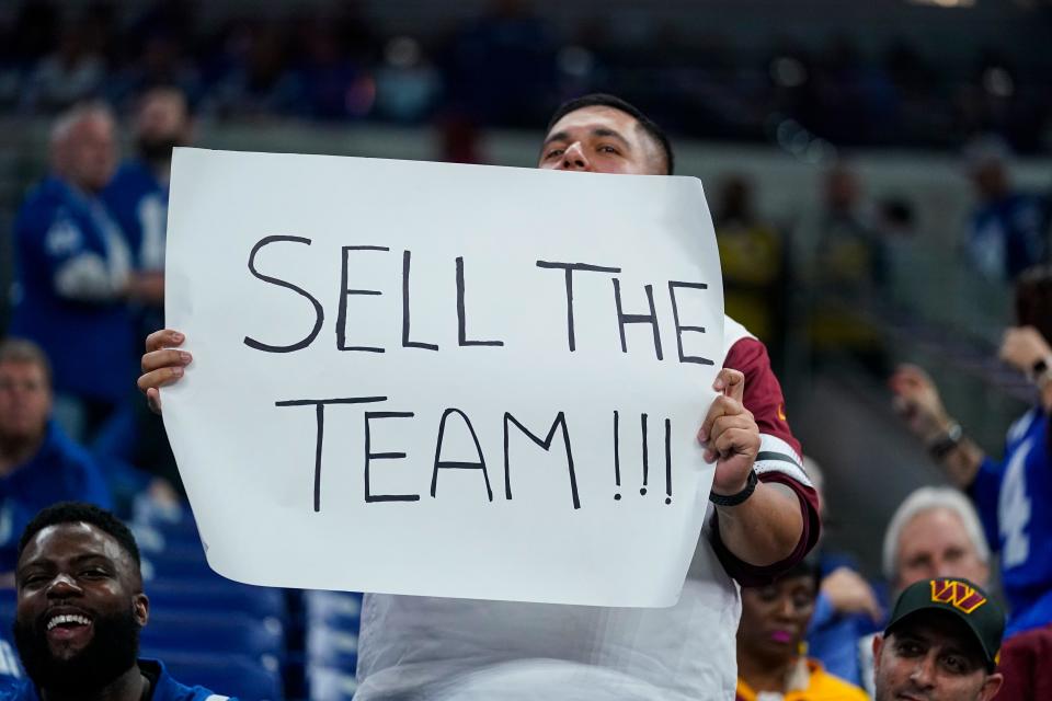 A fan shown in the stands with a "Sell the Team" between the Washington Commanders and the Indianapolis Colts on  Oct. 30, 2022.