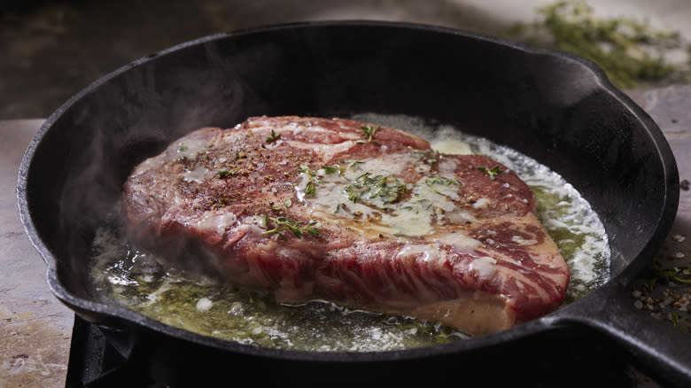 Steak cooking in pan