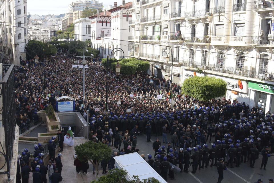 Algerian demonstrators take to the streets in the capital Algiers to protest against the government and reject the upcoming presidential elections, in Algeria, Wednesday, Dec. 11, 2019. Algeria's powerful army chief promises that a presidential election on Thursday will define the contours of a new era for a nation where the highest office has stood vacant for eight months. The tenacious pro-democracy movement which forced leader Abdelaziz Bouteflika to resign after 20 years in power doesn't trust the confident claim and is boycotting the vote. (AP Photo/Toufik Doudou)