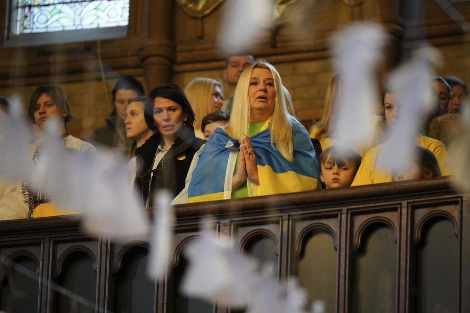 Children from St Mary's Ukrainian School attend an ecumenical prayer service at the Ukrainian Catholic Cathedral in London, to mark the one year anniversary of the Russian invasion of Ukraine, Friday Feb. 24, 2023. (Yui Mok/PA via AP)