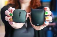 <p>The Microsoft Adaptive Mouse and Tail held in mid-air, facing the camera, by two hands with colorful nails.</p> 