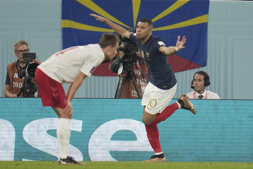 France's Kylian Mbappe celebrates after scoring his side's first goal during the World Cup group D soccer match between France and Denmark, at the Stadium 974 in Doha, Qatar, Saturday, Nov. 26, 2022. (AP Photo/Christophe Ena)