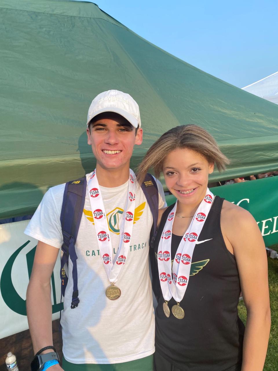 Catholic High School teammates Keegan Smith and Chloe Truss display some of their medals after winning a combined five individual events at the state track and field Division II-AA meet May 24, 2023.