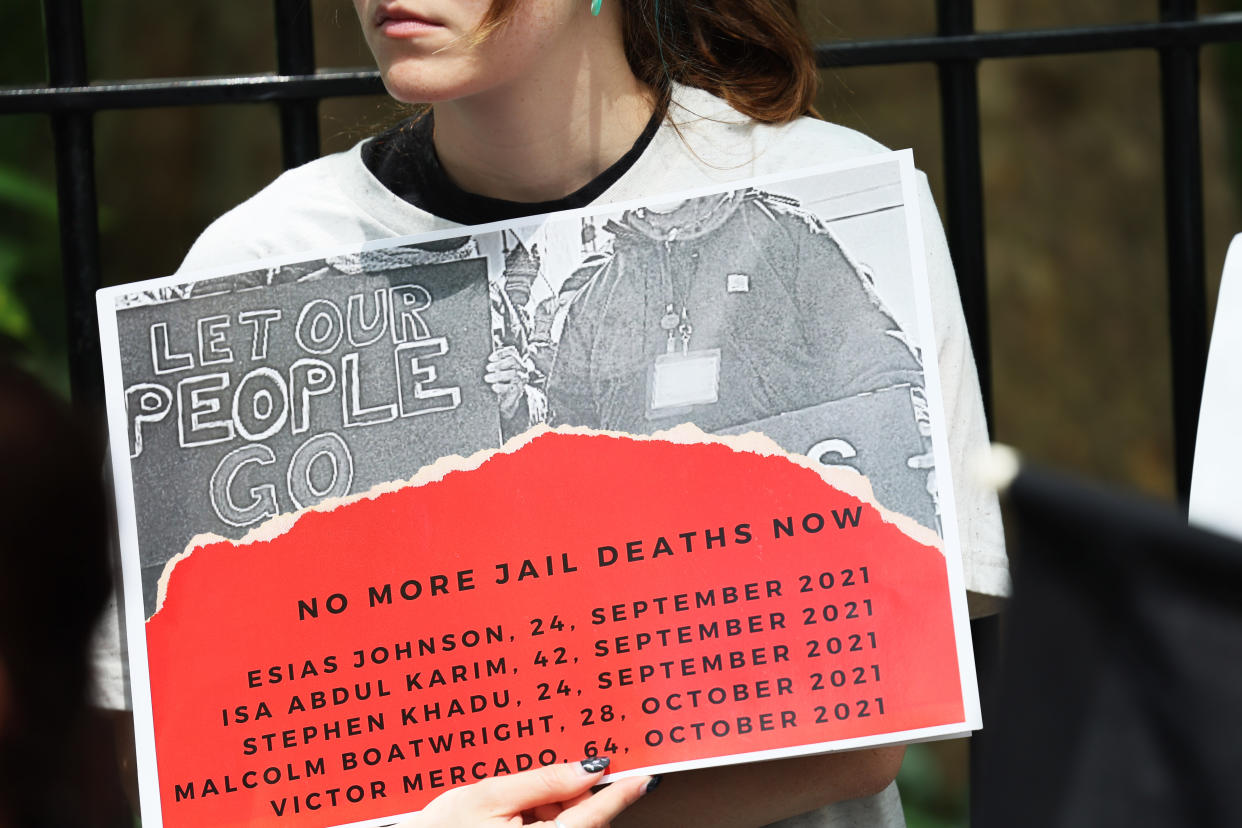 A demonstrator holds a sign saying: Let Our People Go, No More Jail Deaths Now and the names, ages and dates of death of deceased inmates, starting with Esias Johnson, 24, September 2021.  