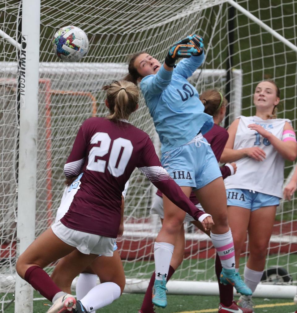 Immaculate Heart Academy goalie Noelle Haskell hits the ball away from Albertus Magnus' Sofia DiPrima during their game at Albertus Magnus Oct. 5, 2022. IMA won 1-0 in 2OT.