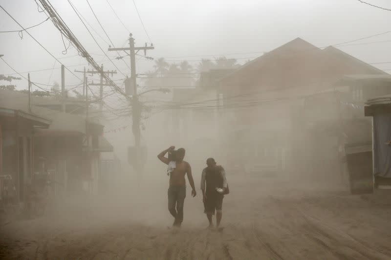 Residents living near the errupting Taal Volcano evacuate in Agoncillo, Batangas City