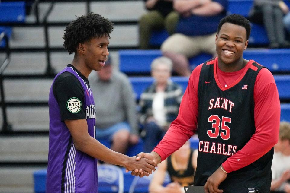 Africentric's Dailyn Swain, left, jokes with St. Charles' Chase Walker before the boys all-star game Friday night at Olentangy Liberty.