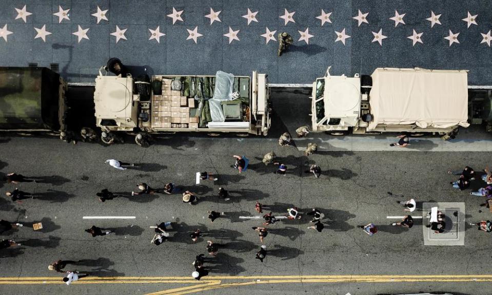 Members of the national guard watch as demonstrators march along Hollywood Boulevard on 2 June 2020, in Los Angeles.