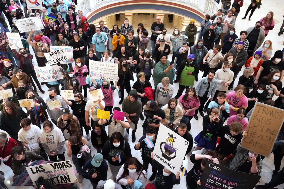 FILE - Trans-rights activists protest outside the House chamber at the state Capitol before the State of the State address in Oklahoma City on Feb. 6, 2023. A bill that would make it a felony punishable by up to 10 years in prison for a medical professional to provide gender affirming medical treatment for those under the age of 18 cleared its first legislative hurdle on Wednesday, Feb. 8, 2023. (AP Photo/Sue Ogrocki, File)