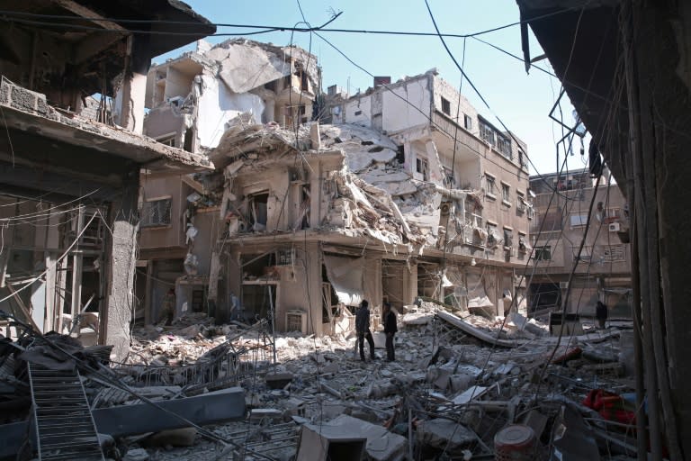 Residents search for survivors amid the rubble of a building following a reported air strike on Damascus' northeastern rebel-held al-Qaboun surburb, on February 24, 2017