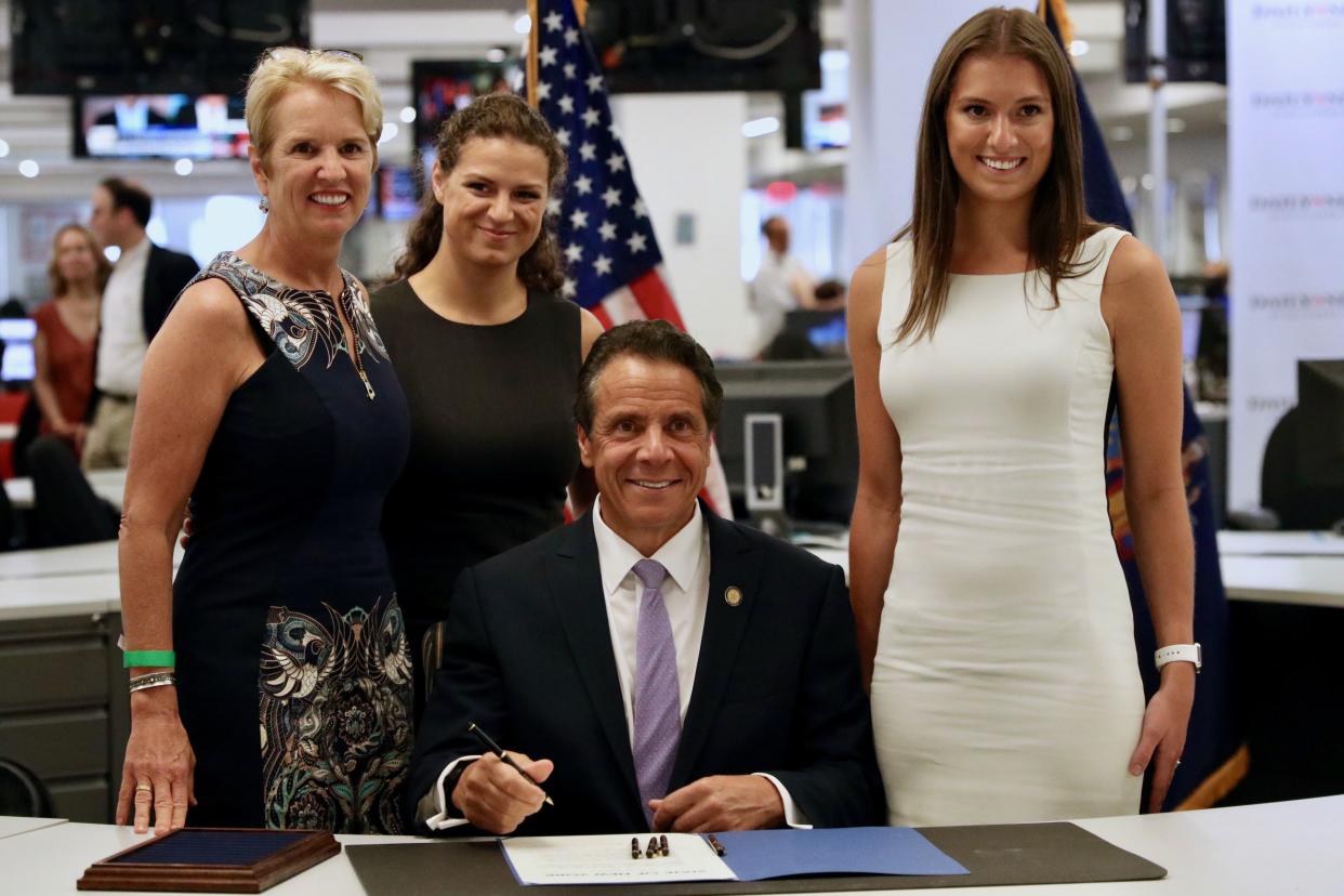 Gov. Andrew Cuomo signed the Farmworkers Fair Labor Practices Act on Tuesday, July 17, 2019 in Manhattan, New York, as his ex-wife Kerry Kennedy (L) and daughters Cara Kennedy Cuomo (2nd L) and Mariah Kennedy Cuomo (R). 