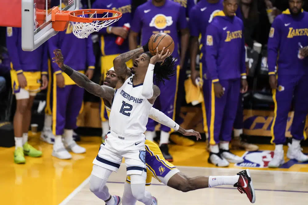 Memphis Grizzlies’ Ja Morant (12) drives to the basket against Los Angeles Lakers’ Jarred Vanderbilt during the first half in Game 6 of a first-round NBA basketball playoff series Friday, April 28, 2023, in Los Angeles. (AP Photo/Jae C. Hong)