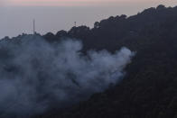 Smoke rises from a fire in a pine forest in Dharmsala, India, Thursday, Oct. 29, 2020. (AP Photo/Ashwini Bhatia)