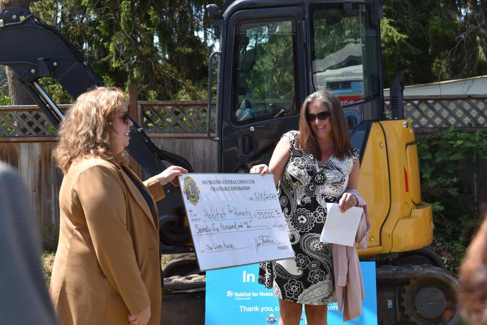 Shannon Michlitsch of Kitsap County's Habitat for Humanity and Amanda Harvey of the Bremerton Central Lions Club show off a check for $75,000 for construction on a new home from the Lions Club.