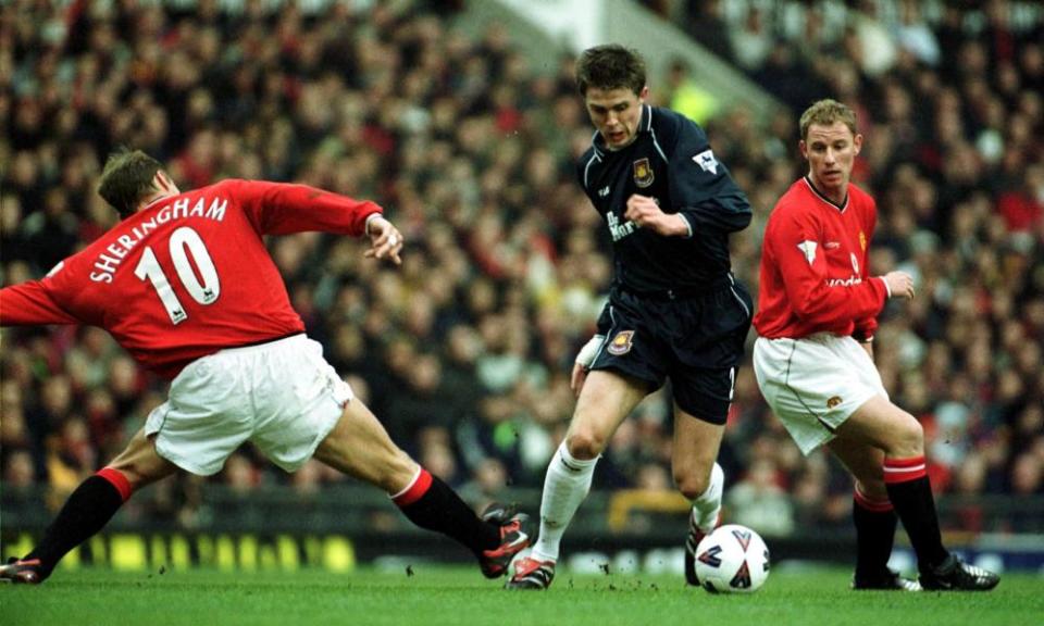 Michael Carrick of West Ham beats Teddy Sheringham of Manchester United.