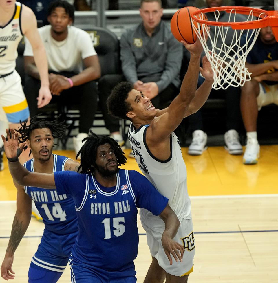 Marquette forward Oso Ighodaro (13) scores on Seton Hall center Jaden Bediako (15) during the second half of their game Saturday, January 27, 2024 at Fiserv Forum in Milwaukee, Wisconsin. Marquette beat Seton Hall 75-57.