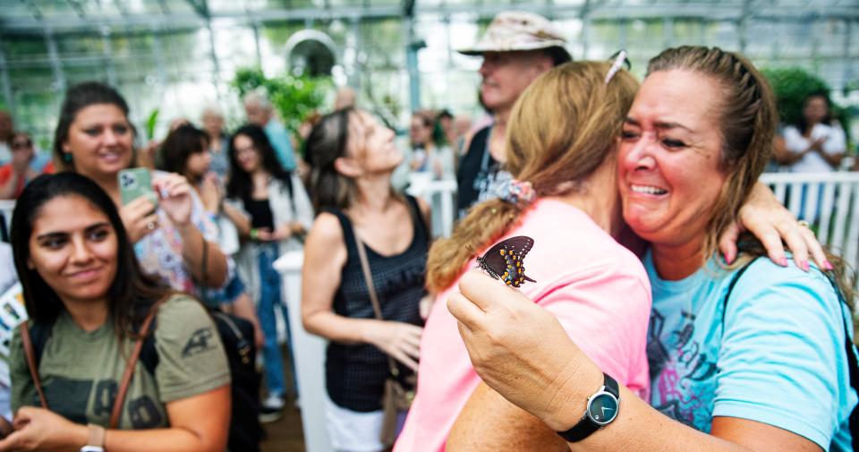 Tamara Gibbs releases a butterfly while Elizabeth Wilkerson gives her a hug during the last butterfly release at the Florida Native Butterfly Society’s butterfly house in Fort Myers on Friday, July 28, 2023. The Florida Native Butterfly Society’s butterfly house closed on Friday. Gibbs is a former employee and supporter of the estates and Wilkerson is the butterfly breeder.